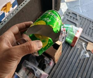 torn soda bottle in vending machine
